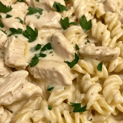 In today's culinary exploration, we delve into a comforting and indulgent dish that is sure to satisfy your cravings: Creamy Garlic Butter Chicken and Rotini in Parmesan Sauce. This delightful recipe combines tender chicken, al dente pasta, and a rich, creamy sauce that envelops every bite. Crafted with a blend of fresh ingredients and robust flavors, this dish is more than just a meal; it's a heartwarming experience that brings family and friends together around the dinner table.